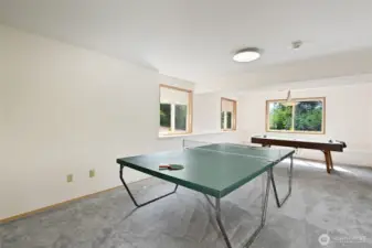 Rec room ready for ping pong and air hockey in daylight basement