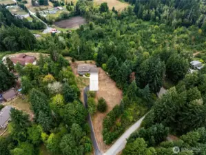Aerial of house on treed acreage with potential to subdivide the 18+ acres.  Front lot to right of driveway is not included.