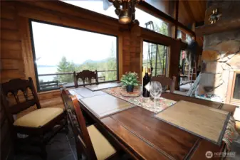 Open dining space with room for gathering, perfectly placed to enjoy water views during every meal