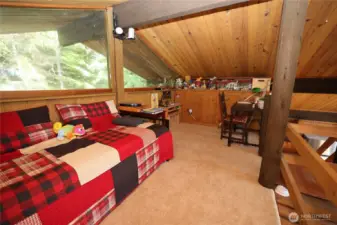 Open upper-level landing that enhances the home’s airy feel and connection