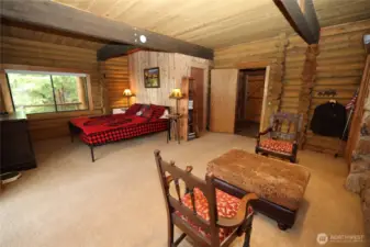 Spacious bedroom with wood accents and natural light, designed for comfort and simplicity