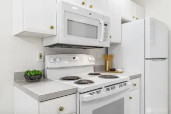 A sleek, modern kitchen awaits with stainless steel appliances, ample cabinetry, and beautiful countertops.