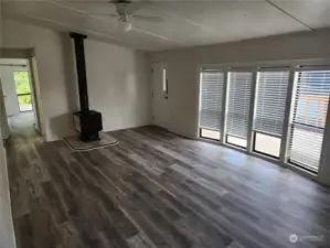 Living room with floor to ceiling windows and wood burning fireplace for our upcoming cold winter days