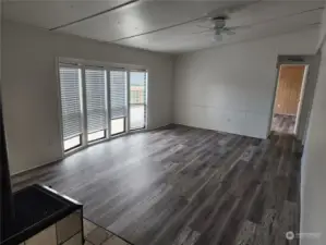 Living room with primary bedroom door in far right corner