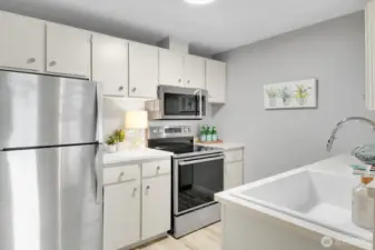 Ample cabinet space and new lighting fixture along with stainless appliances update the kitchen nicely.