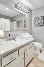 Spacious full bath also offers new quartz counters, sink, toilet and lighting.