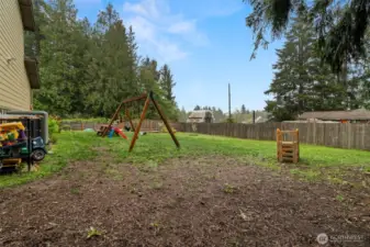 Huge yard is fully fenced and ready for play, gardening or entertaining.
