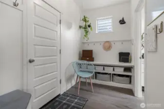 The mud room with storage is just off the garage, the powder room is to the right.