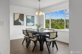 Spacious dining area with new laminate flooring.