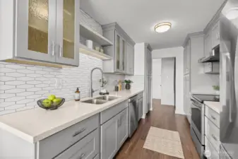 From the galley kitchen, looking toward the entry and showcasing the thoughtful flow and seamless design throughout the home.