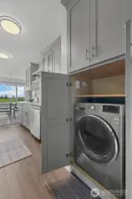Tucked into the sleek custom cabinetry, you'll find a hidden combo washer/dryer for convenience and compatibility.