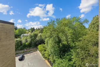 From the breezeway, enjoy a peek at the lush greenbelt and the Burke-Gilman Trail just below. Perfect for daily walks, bike rides, or simply soaking in the view. The large private parking area is available for you and your guests.