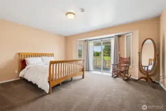 Primary bedroom overlooks the golf course with a sliding door to the back deck.