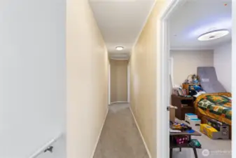 As you come up to the second level there are two children's bedrooms on the left side.  The Primary Bedroom is at the end on the left side.  Ther is another bedroom behind and full bathroom behind this photo.