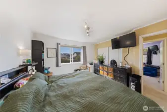 This photo shows the Primary Bedroom.  You can see the second child's bedroom through the doorway.  The Primary Bathroom is located to the right of this picture.