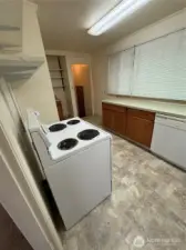 Kitchen has a stove and refrigerator and dishwasher