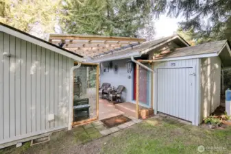 Looking from the yard to the back patio and sheds