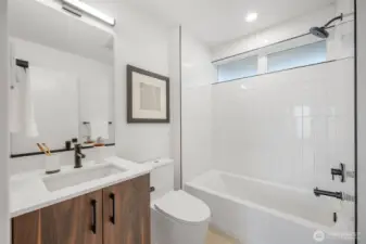 Lower Level full bathroom.   Photos are of model home of same floorplan. Color schemes will vary.