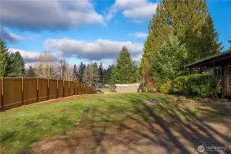 Large front yard enhanced by a newly installed cedar fence, adding both privacy and a polished, updated look.