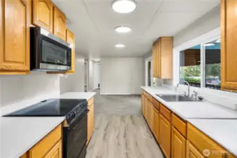 Spacious open-concept kitchen offers NEW LVP FLOORING, excellent flow, abundant storage, and sightlines to adjacent living areas.