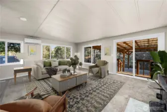 Open-concept living area offers generous space for gathering and connects seamlessly to the covered patio for indoor-outdoor living. Newer mini-split provides additional A/C & heat when needed.   (photo virtually staged)