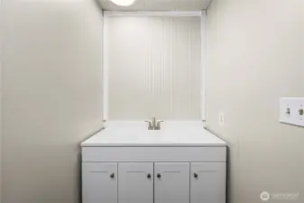 Convenient primary half bath features a new vanity and toilet, ideal for everyday use.