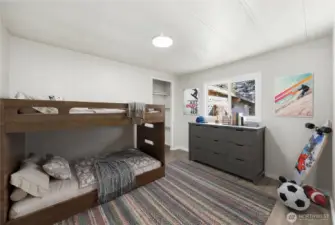 Spacious bedroom offers a comfortable setting with luxury vinyl plank flooring, updated LED lighting, and a new double-paned vinyl window that brings in natural light.  (photo virtually staged)