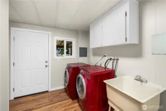 Spacious utility room provides modern front-load washer & dryer included, new LVP flooring, mud sink & abundant storage.