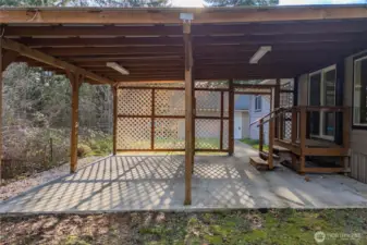 Covered back patio creates a private outdoor retreat perfect for relaxing, entertaining, or enjoying the peaceful surroundings.