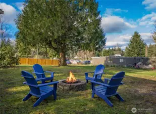 Relaxing side yard firepit area creates a perfect gathering spot to enjoy evenings under the stars.  (photo virtually staged)