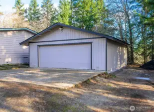 Detached 2-car garage provides secure parking, additional storage, and flexible workspace potential. RV/boat/trailer parking right next to garage--new gravel piles will be spread soon!