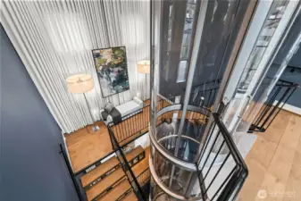 Ride in style. The glass cab offers shifting perspectives of the curated interiors and custom art walls as you glide between the three floors.