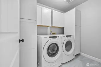 Upstairs laundry room with built in cabinets