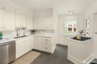 Kitchen has been refreshed with new quartz countertops, paint & floors and flows nicely into the living/dining area.