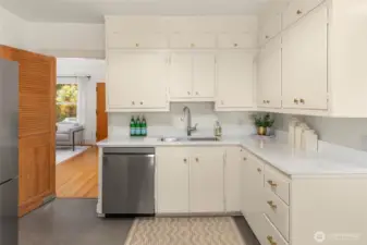 Kitchen has been refreshed with new quartz countertops, paint & floors and flows nicely into the living/dining area.