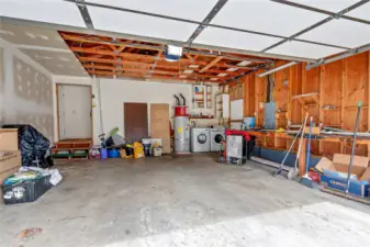 Two car garage interior. Laundry area in garage, washer/dryer included.