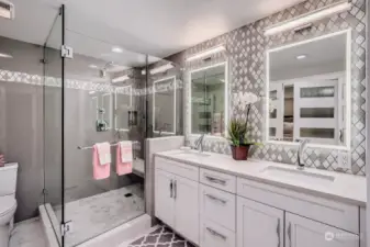 This primary bath has heated floors, lighted mirrors, tiled shower with seat!