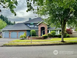 Impressive home on corner lot with mature landscaping.