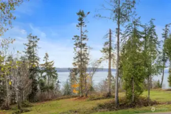 With a wall of glass and huge slider doors to the upstairs deck off the grand oversized space above the garage, you are met with thrilling views of the iconic Brothers peak to the West, and 180* views of the Hood Canal to the South and East.