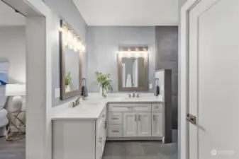 Main level primary suite offers a gorgeous ensuite bath, with double vanities, walk in closet, and a private water closet.