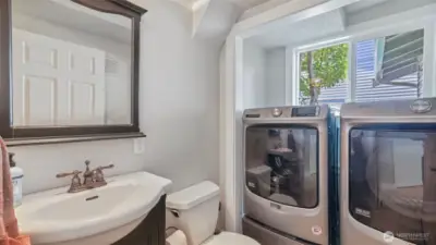 Convenient ½ bathroom connected to the laundry area, with washer and dryer included for your ease
