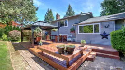 The charming gazebo stays, making this wooden porch perfect for year-round BBQs and relaxed patio hangouts