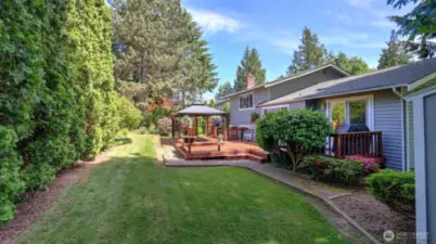 Beyond the porch, enjoy a spacious grassy yard—ideal for recreational activities and outdoor fun.