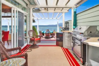 The deck features a high-end outdoor kitchen/ BBQ