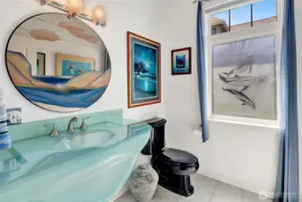 Half bathroom has a beach theme (mirror does not convey)