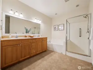 5-piece primary ensuite features double vanity, soaking tub and large rain-head shower.