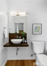 Simplicity with style. The main-level powder room offers clean lines, warm wood tones, and quiet sophistication—proof that even the smallest spaces at Harold’s Place are thoughtfully considered.