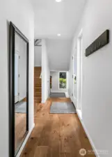 A light-filled ascent. Framed by soaring ceilings and generous windows, this stairway transition reveals the home’s vertical elegance—drawing the eye upward and flooding each level with natural light.