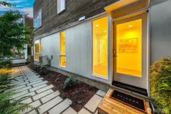 A warm welcome from the garden path. The lower-level entry offers privacy and flexibility—ideal for guests or multi-generational living—set along a thoughtfully landscaped path at the heart of Harold’s Place.
