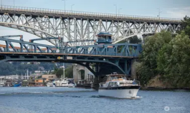 Where movement meets memory. Boats glide beneath the iconic Fremont Bridge, connecting neighborhoods, histories, and daily rhythms. Just below Harold’s Place, this working waterway reminds us that in Seattle, the journey is part of the view.